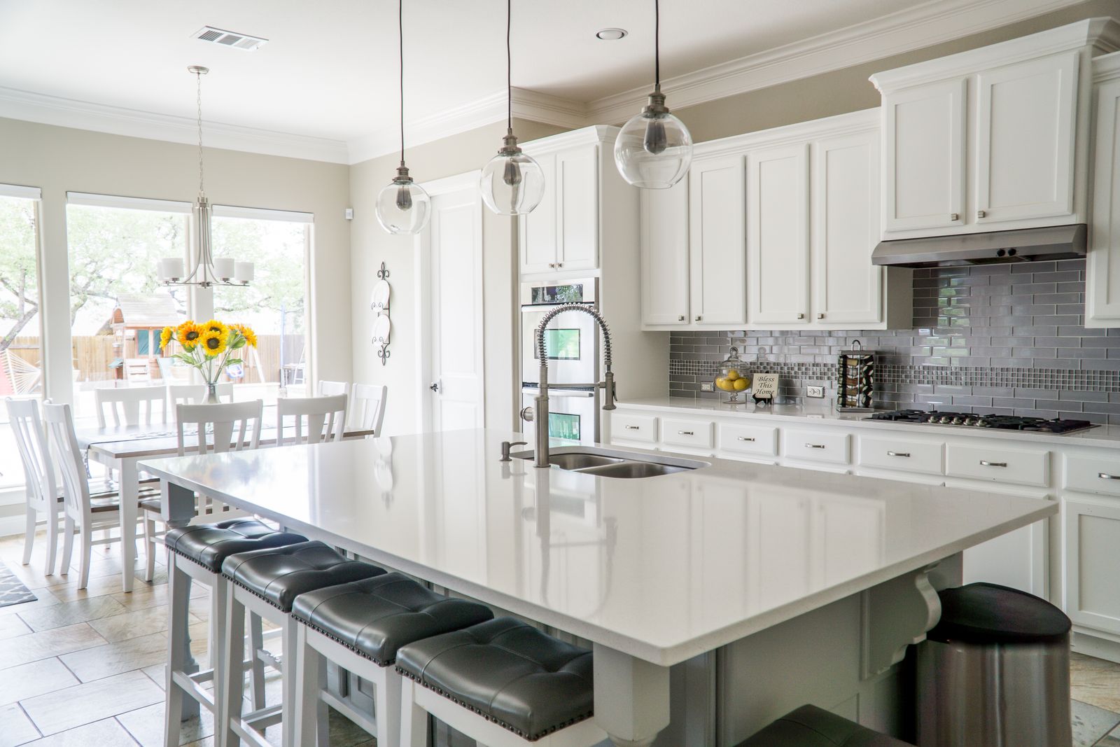 A bright white kitchen with a clear island counter