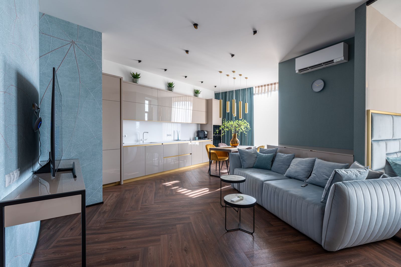 A tidy open-plan living room with sofa